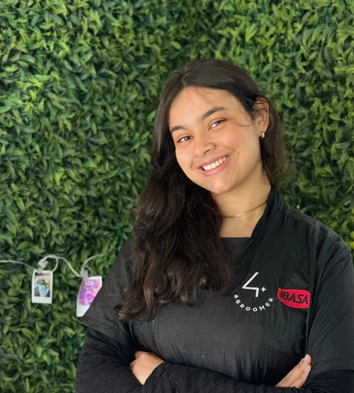 Luiza Nunes sorrindo, de uniforme de groomer